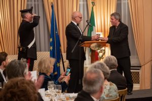 Adrian being saluted by the attending Carabinieri as Ambassador Trombetta presents the award
